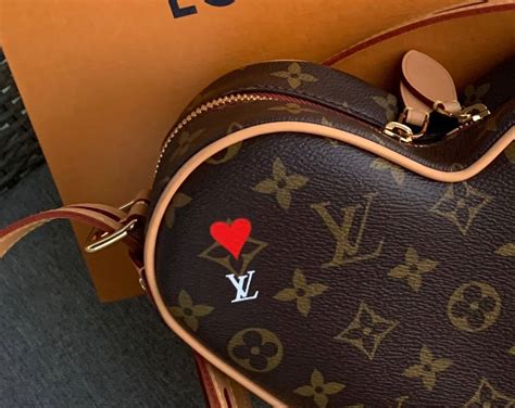 handbags with heart shaped emblem